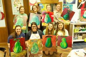 Students supporting Woodruff’s service-learning course group at their fundraising event called “Masterpieces for Meals” at Uptown Art, benefitting Secret Meals for Hungry Children. Credit: Maggie Woodruff.